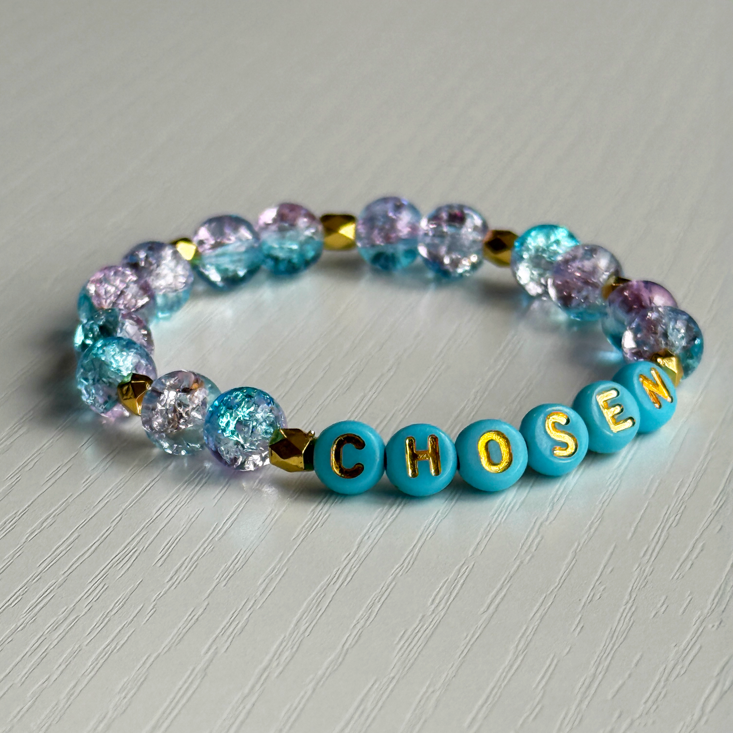 Bracelet with colorful beads and 'CHISEN' beads on a light gray background