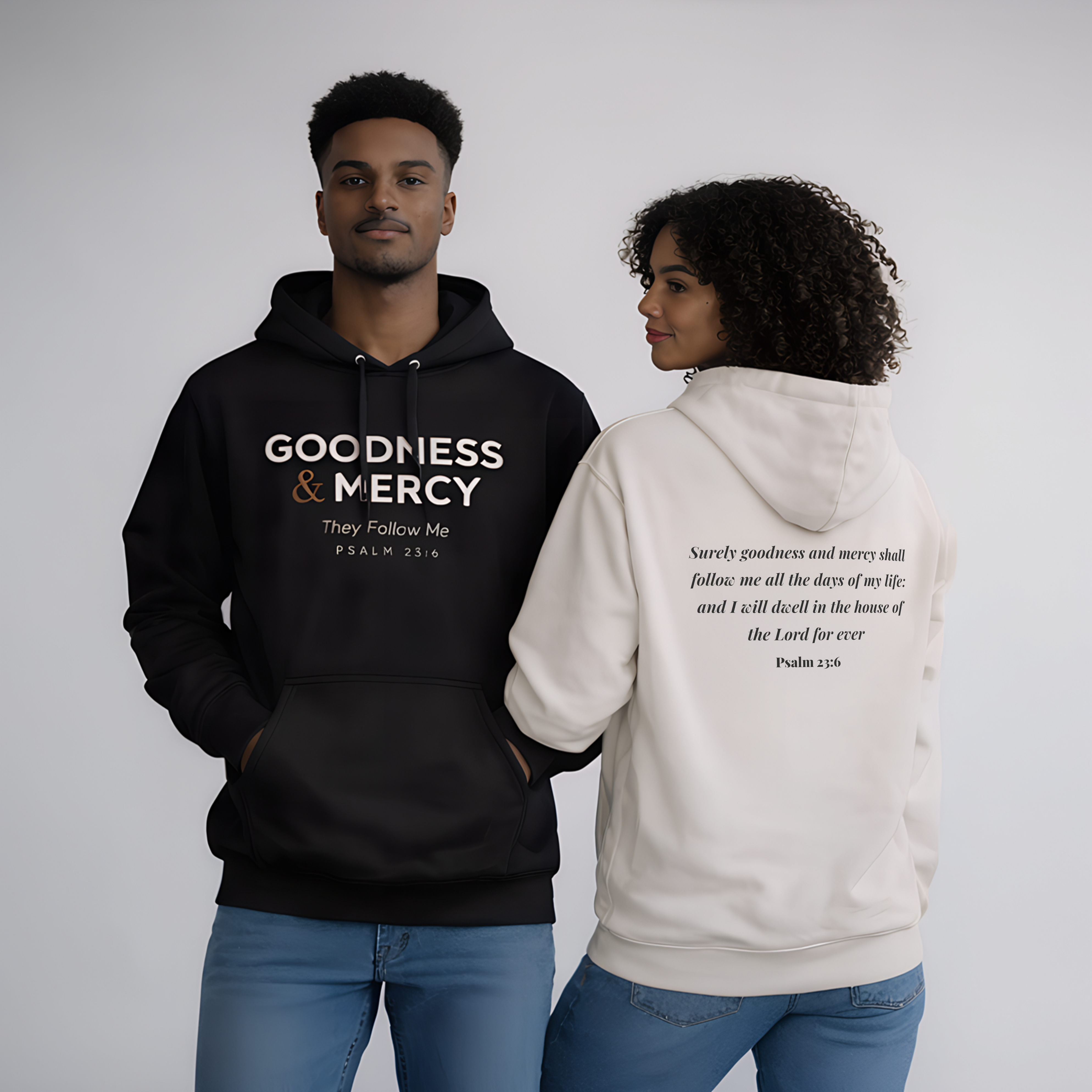 Two people wearing hoodies with text on a plain background