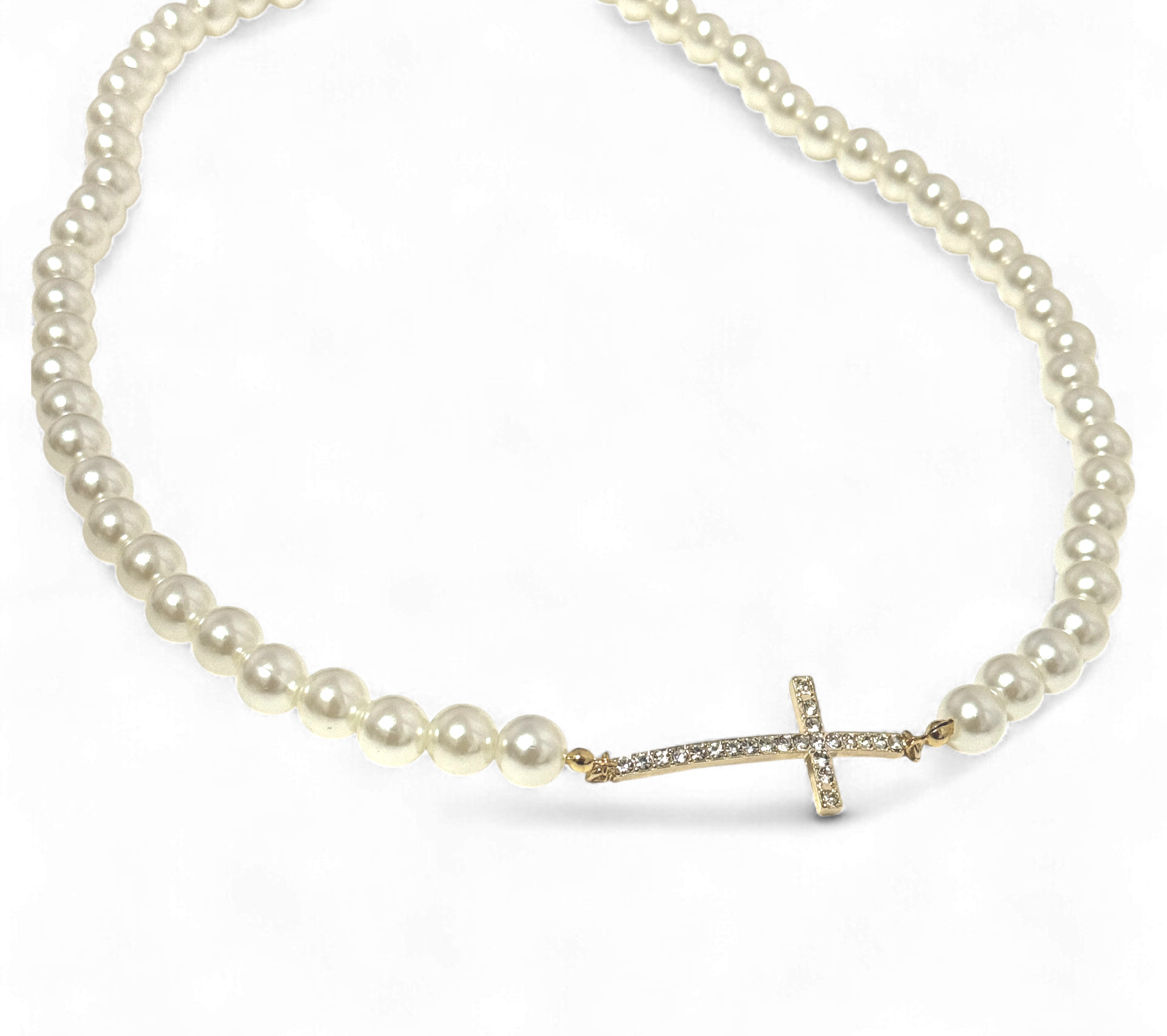 Pearl necklace with a gold cross pendant on a white background