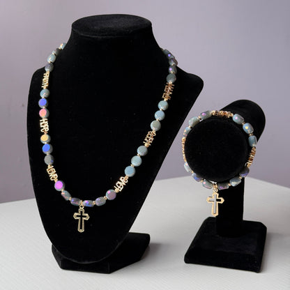 Necklace and earrings on black velvet stands against a white background