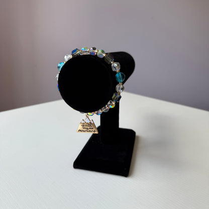 Black bow tie with colorful beads on a white background