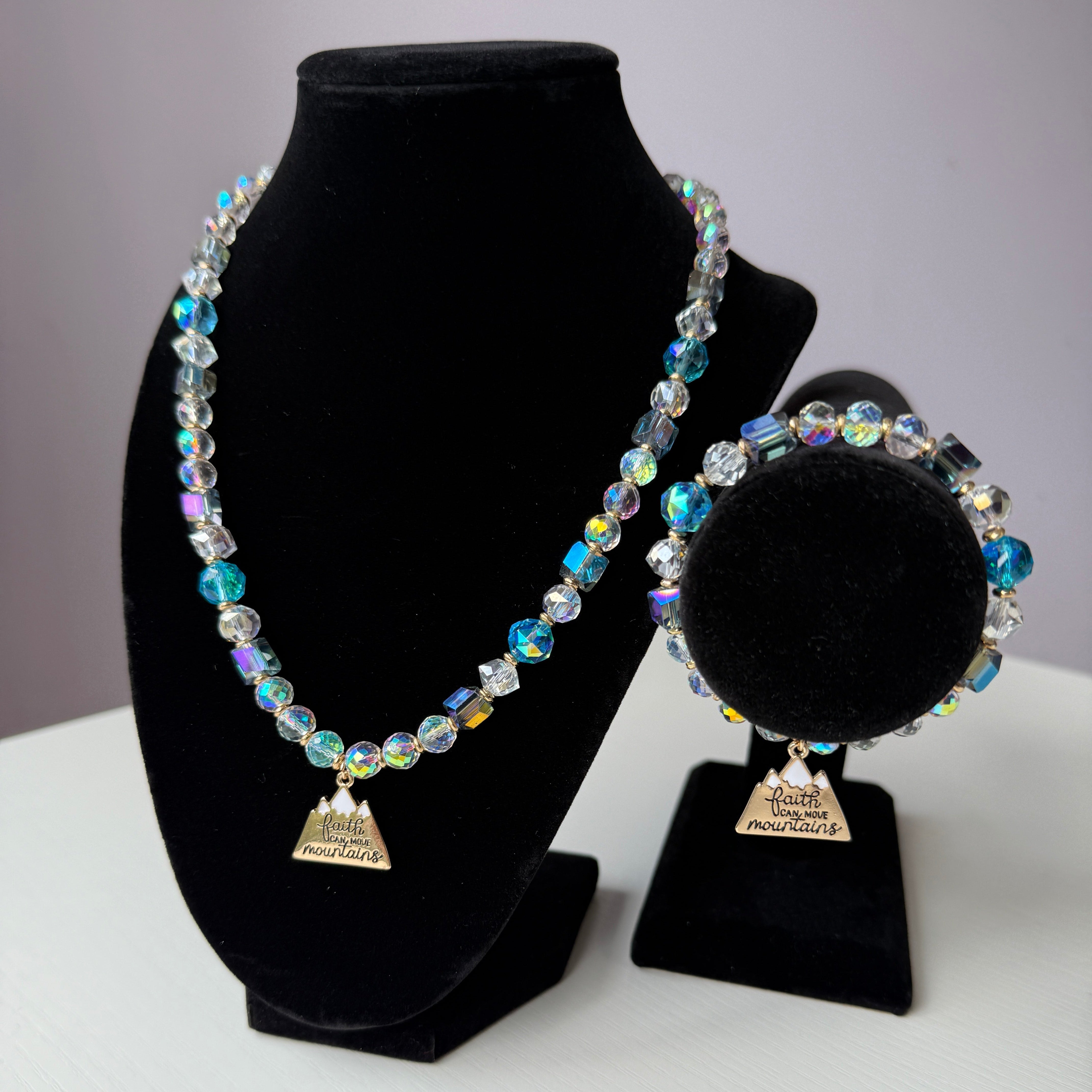 Necklace and bracelet set on a black velvet stand with a white background