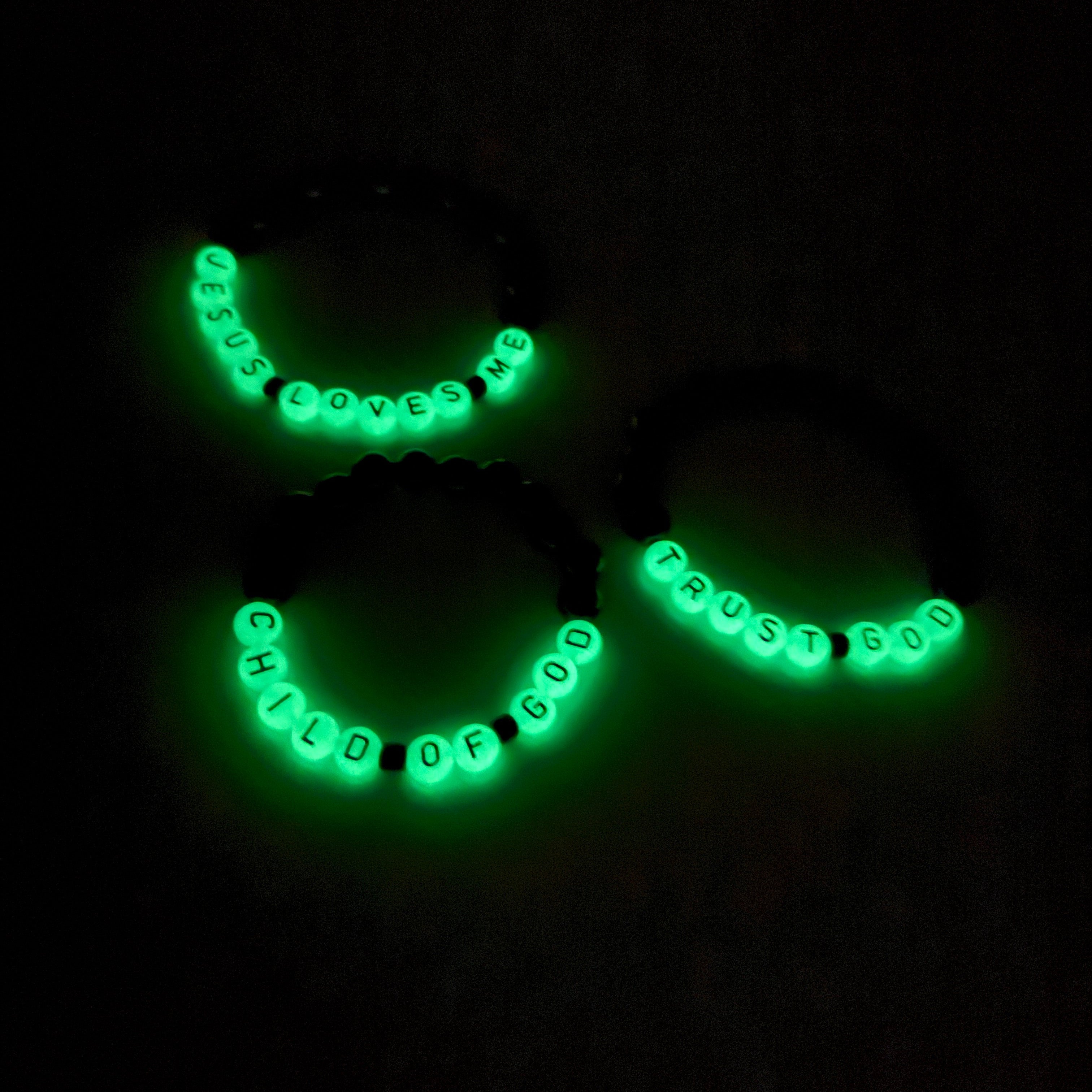 Glowing green necklace with text on a black background