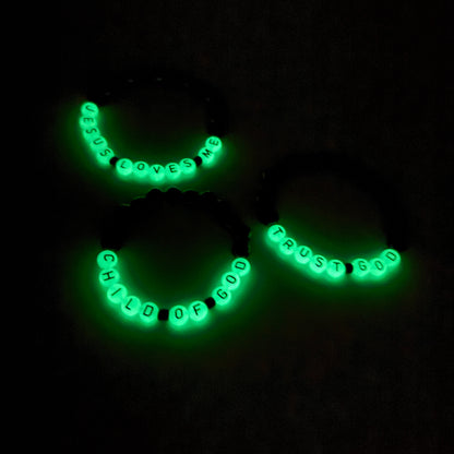 Glowing green necklace with text on a black background