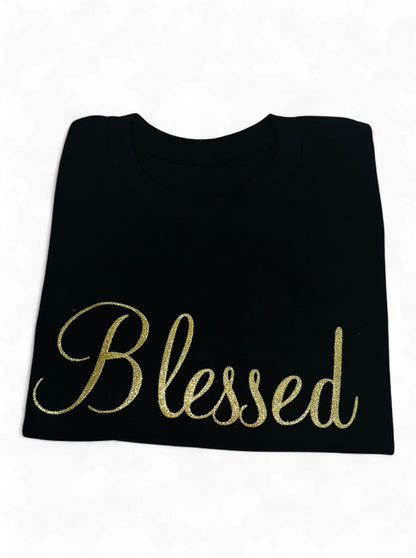 Black t-shirt with 'Blessed' in gold on a white background