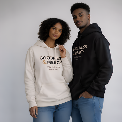 Two people wearing 'Goodness & Mercy' hoodies against a plain background