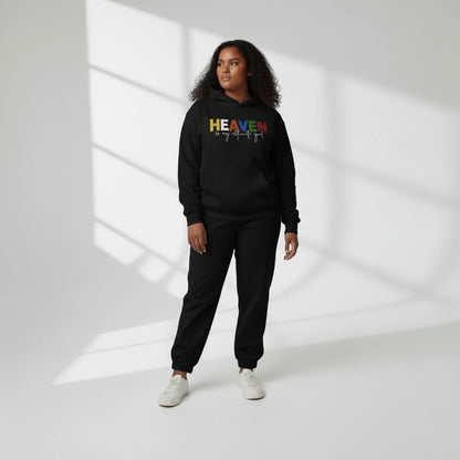 Person wearing a black sweatshirt with 'HEAVEN' printed on it against a white background