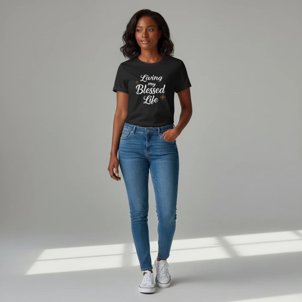 Woman wearing a black t-shirt with 'Living a Blessed Life' text and blue jeans on a gray background