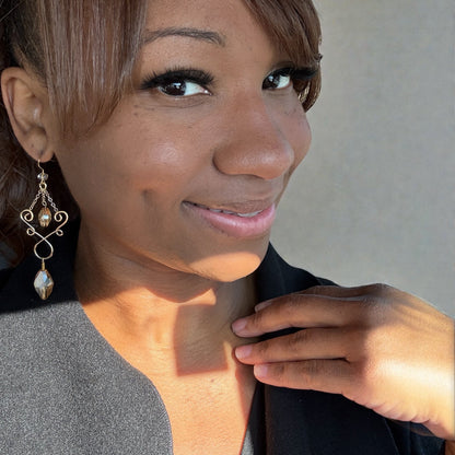 Woman wearing earrings with a neutral background