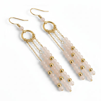 Pair of beaded earrings with gold accents on a white background