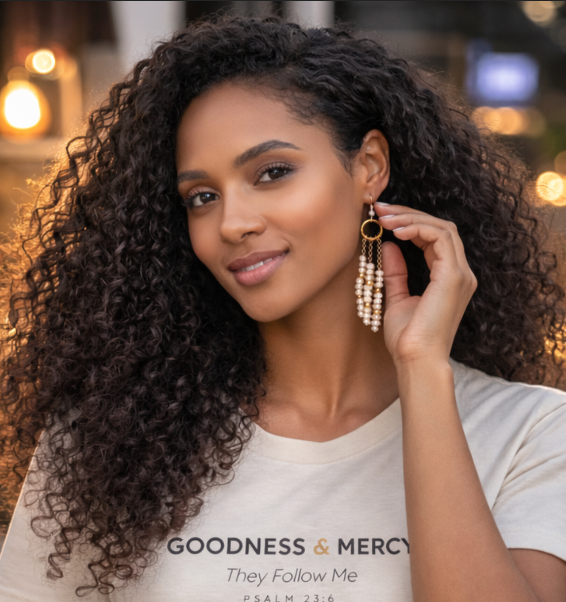 Woman wearing gold earrings with a blurred background